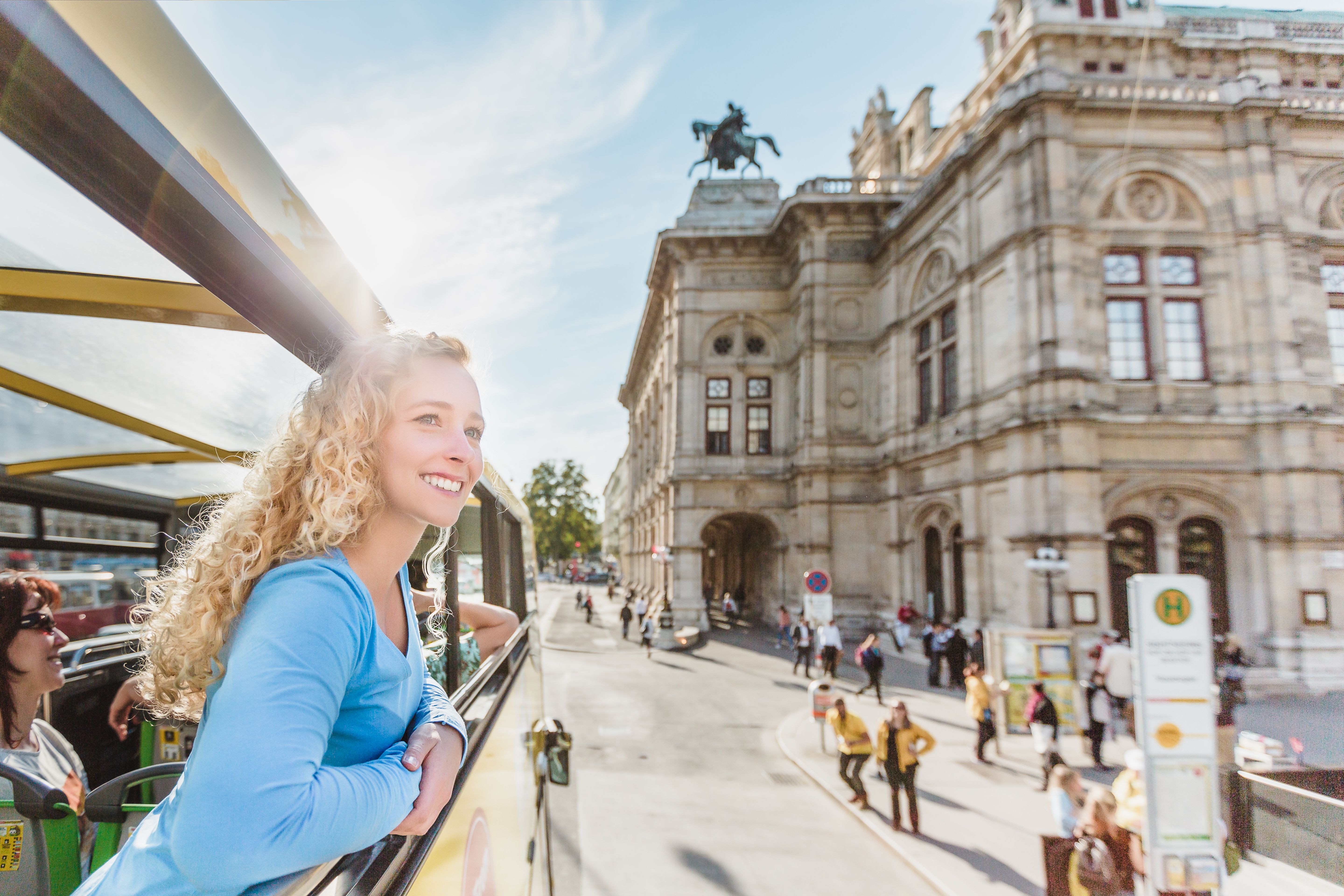Frau schaut aus Sightseeingbus in Wien