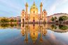 Karlskirche Wien in der goldenen Stunde wird im Wasser gespiegelt