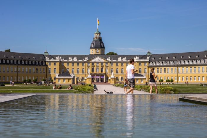 Schloss Karlsruhe von vorne mit Park und Brunnen im Vordergrund