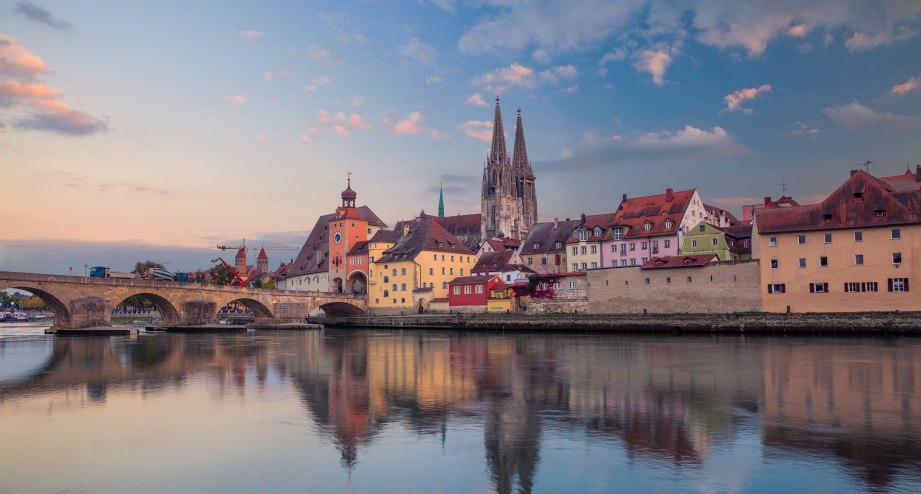 Regensburger Altstadt in der Dämmerung vom Wasser aus aufgenommen - BAHNHIT.DE, © getty, Foto: RudyBalasko