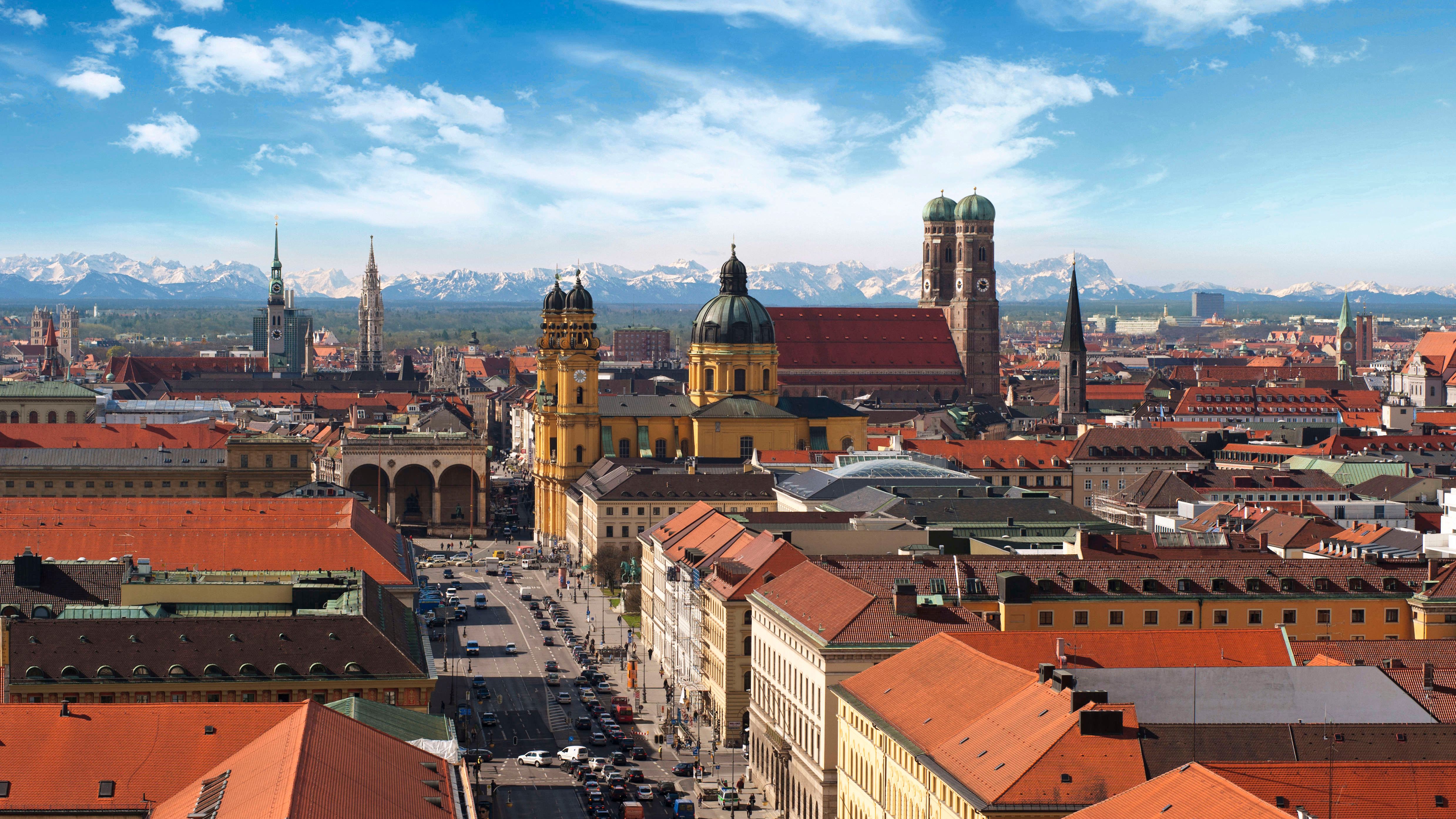 Alpenpanorama hinter Münchens Stadtsilhouette